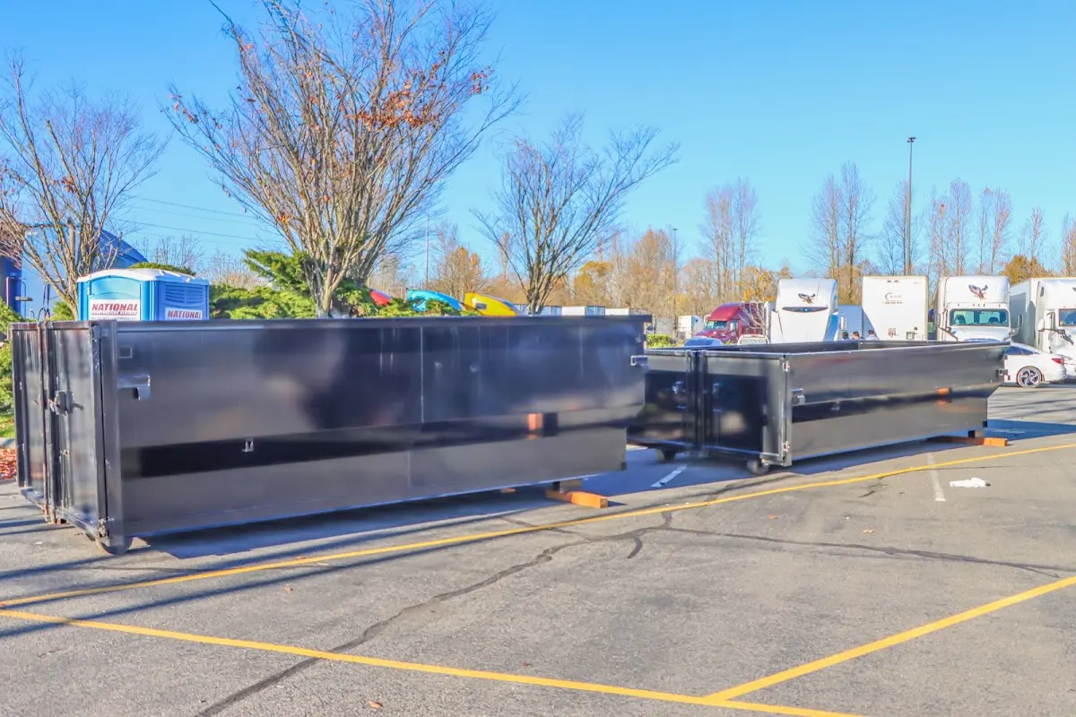 Professional dumpster rental service with roll-off container on residential driveway in New Milford